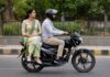 Women sit sideways bike